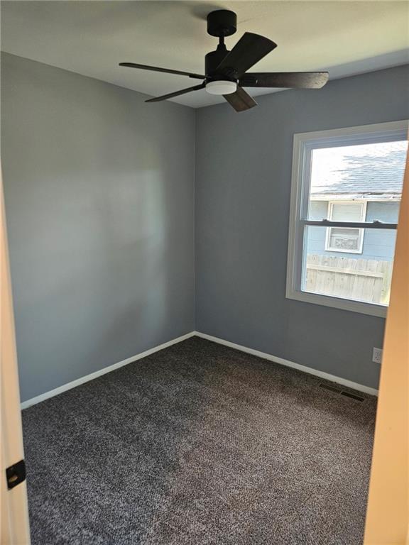 4715 E 45th St, Kansas City, MO 64130 - empty room with carpet, a ceiling fan, and baseboards