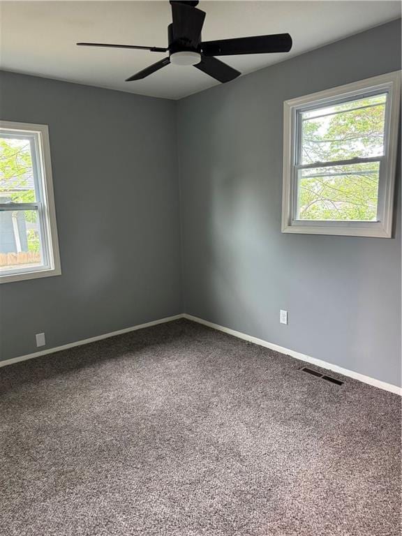 4715 E 45th St, Kansas City, MO 64130 - carpeted empty room featuring healthy amount of natural light, baseboards, and a ceiling fan