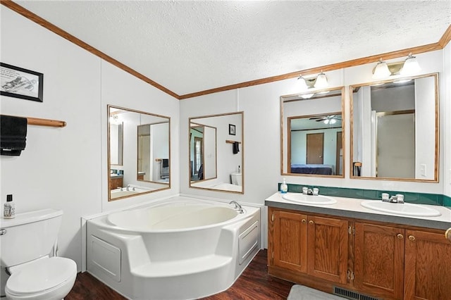 39460 Indianapolis Rd, Lane, KS 66042 - bathroom featuring ornamental molding, wood finished floors, double vanity, a textured ceiling, and vaulted ceiling