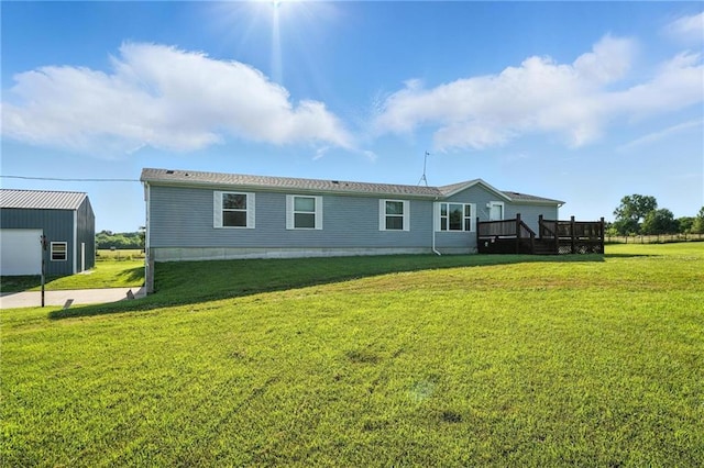 39460 Indianapolis Rd, Lane, KS 66042 - back of house with a deck, a yard, and an outbuilding
