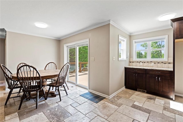 21815 W 73rd Ter, Shawnee, KS 66218 - dining area with baseboards, stone tile floors, and crown molding
