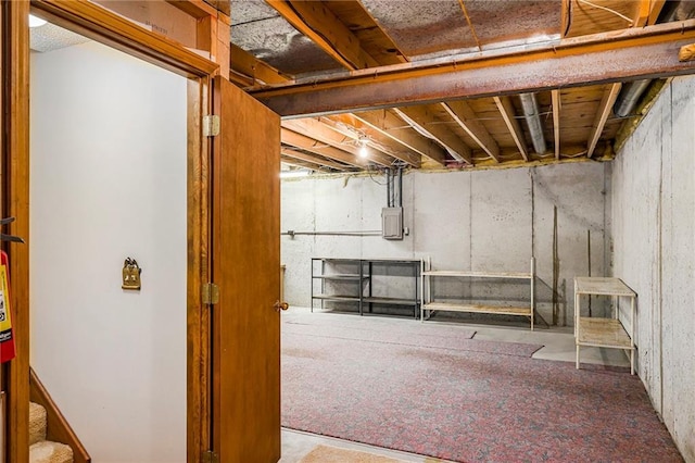 unfinished basement featuring electric panel