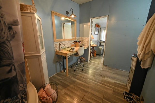 bathroom with backsplash and wood finished floors
