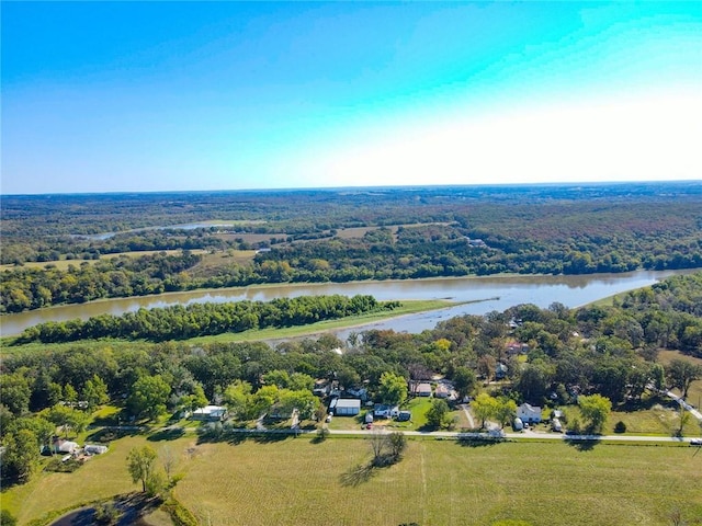 bird's eye view of a nearby body of water and a heavily wooded area