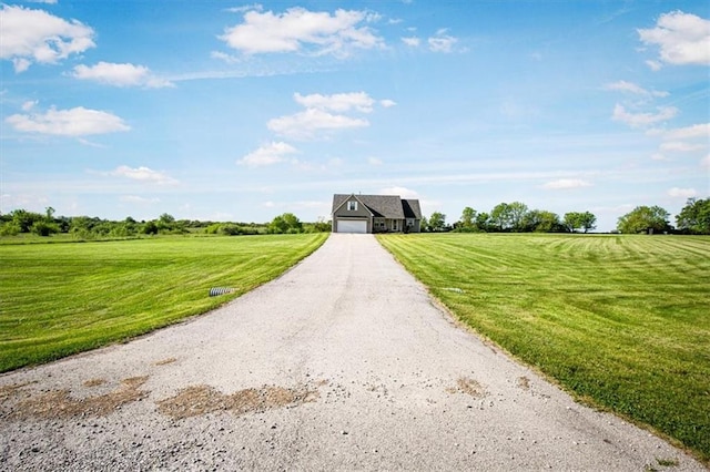 view of dirt / gravel road featuring a rural view