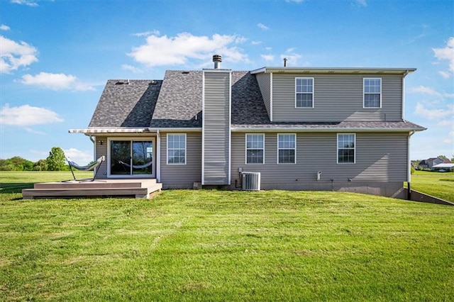 back of house featuring a yard, a deck, central AC, and a chimney