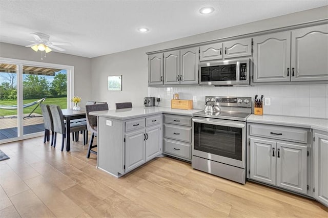 kitchen featuring stainless steel appliances, gray cabinets, recessed lighting, and a textured ceiling