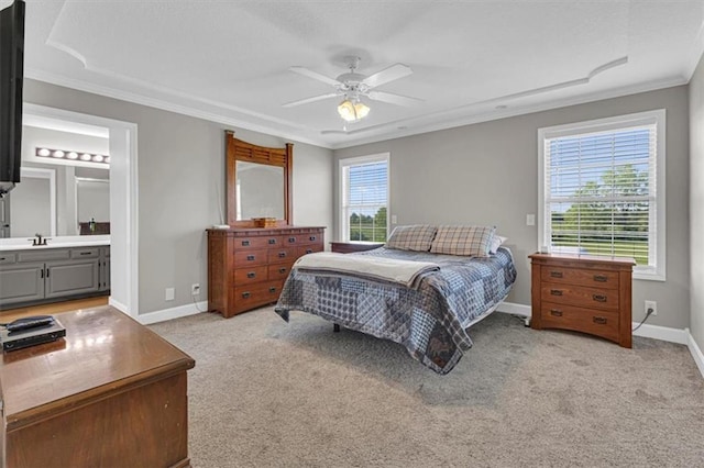bedroom with crown molding, light carpet, baseboards, connected bathroom, and ceiling fan