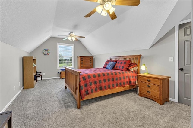 bedroom featuring carpet, vaulted ceiling, baseboards, a textured ceiling, and ceiling fan