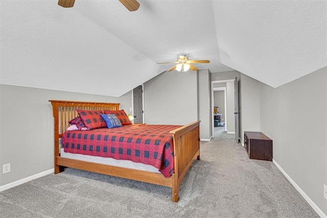 carpeted bedroom with lofted ceiling, baseboards, ceiling fan, and a textured ceiling