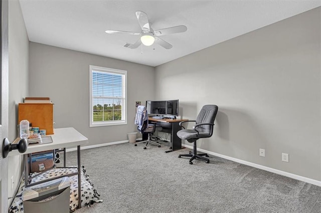 carpeted home office with baseboards and ceiling fan