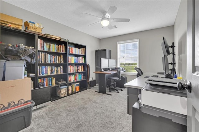 office area featuring carpet floors, ceiling fan, and a textured ceiling
