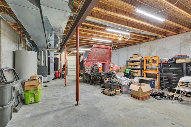 unfinished basement featuring heating unit and gas water heater