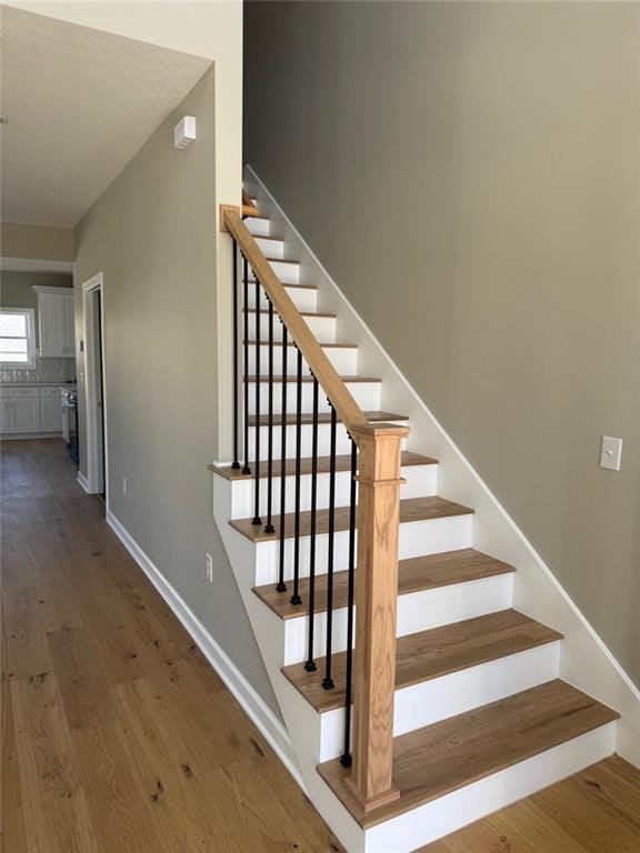 305 N Prairie St, Hamilton, MO 64644 - stairway featuring wood finished floors and baseboards