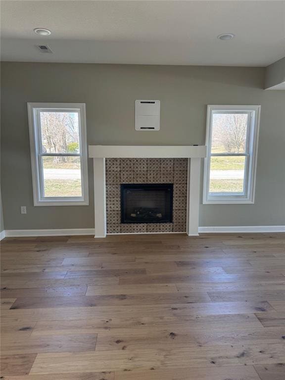 305 N Prairie St, Hamilton, MO 64644 - unfurnished living room featuring baseboards, wood finished floors, and a fireplace