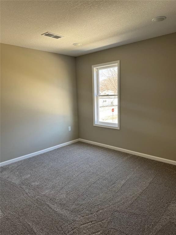 305 N Prairie St, Hamilton, MO 64644 - spare room featuring carpet, a textured ceiling, and baseboards