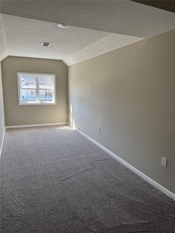 305 N Prairie St, Hamilton, MO 64644 - carpeted empty room featuring vaulted ceiling, a textured ceiling, and baseboards