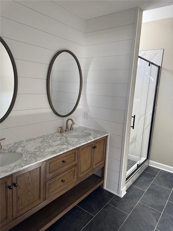 305 N Prairie St, Hamilton, MO 64644 - full bathroom featuring a shower stall, double vanity, baseboards, and tile patterned floors
