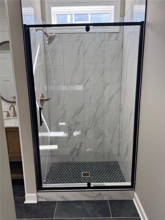 305 N Prairie St, Hamilton, MO 64644 - bathroom featuring vanity, a stall shower, and baseboards