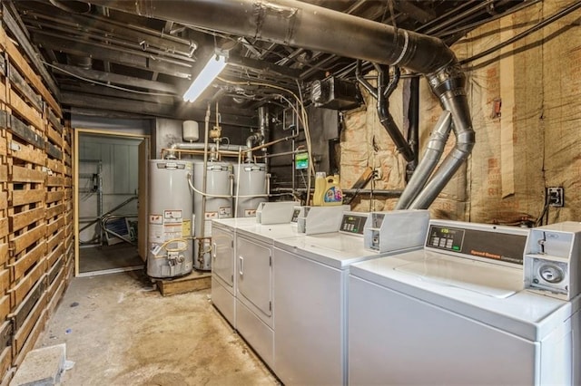 clothes washing area featuring washing machine and clothes dryer and gas water heater