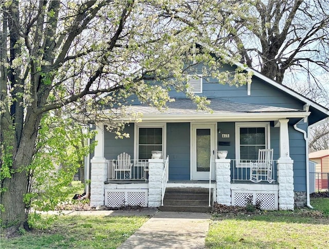 view of front of home with a porch and a shingled roof