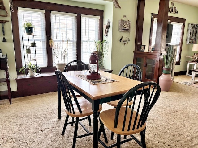 dining area featuring light colored carpet