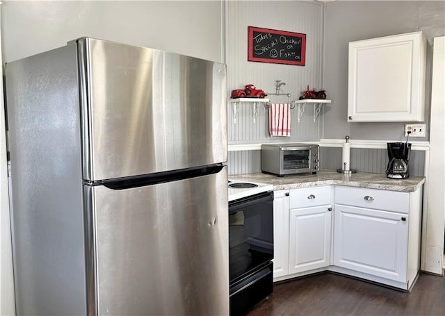 kitchen featuring freestanding refrigerator, electric stove, white cabinets, dark wood-type flooring, and open shelves
