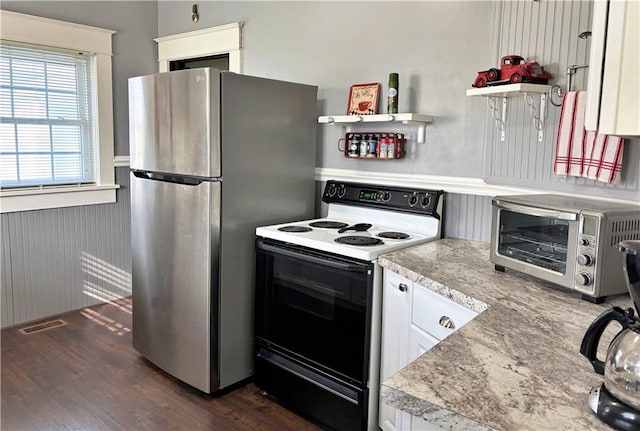 kitchen with electric range, open shelves, freestanding refrigerator, dark wood-style floors, and white cabinetry