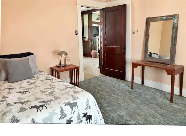carpeted bedroom featuring baseboards