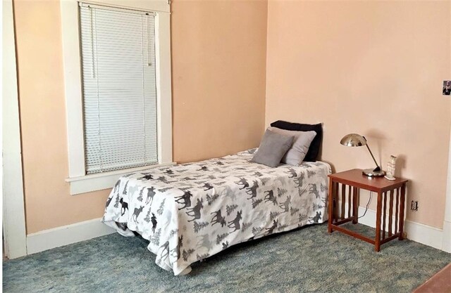bedroom with carpet and baseboards
