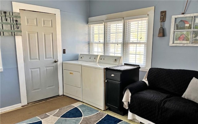 clothes washing area with washer and clothes dryer