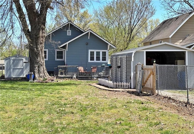 back of house with a shed, an outbuilding, and a wooden deck