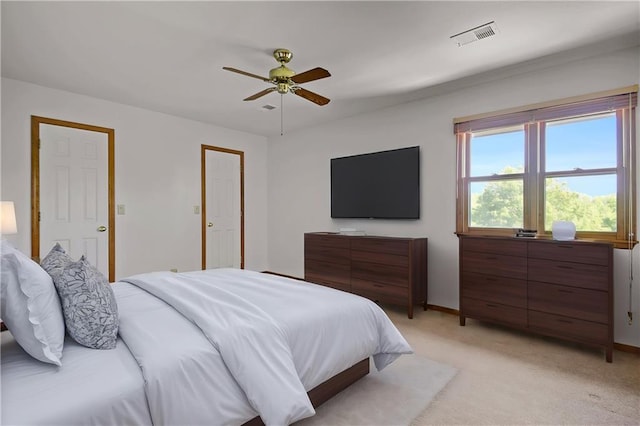 bedroom featuring light colored carpet, ceiling fan, and baseboards