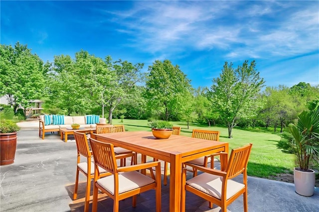 view of patio featuring outdoor lounge area, view of scattered trees, and outdoor dining space