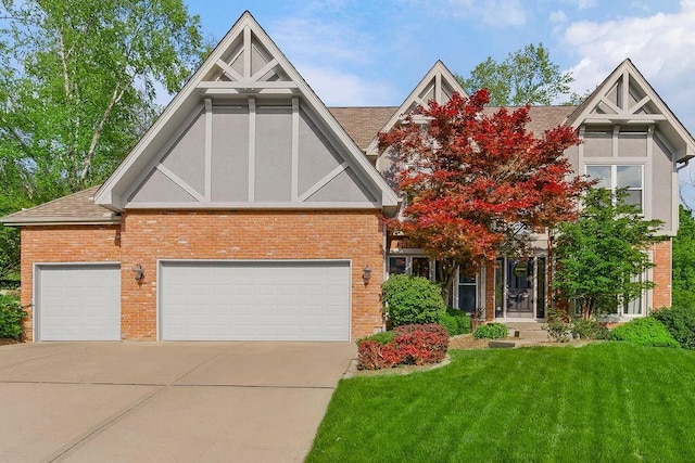7711 N Montgall Ave, Kansas City, MO 64119 - tudor house featuring brick siding, driveway, a front yard, and roof with shingles