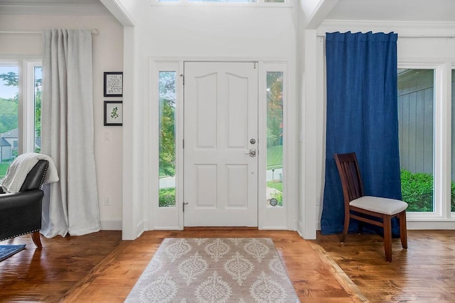7711 N Montgall Ave, Kansas City, MO 64119 - foyer with wood finished floors, baseboards, and crown molding