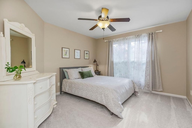 7711 N Montgall Ave, Kansas City, MO 64119 - bedroom featuring baseboards, light carpet, and ceiling fan