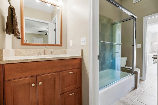 7711 N Montgall Ave, Kansas City, MO 64119 - bathroom featuring tile patterned floors, vanity, a ceiling fan, and toilet