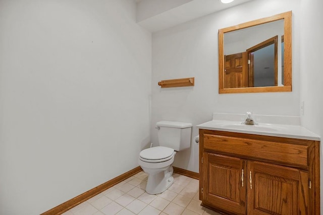 7711 N Montgall Ave, Kansas City, MO 64119 - half bath featuring baseboards, toilet, vanity, and tile patterned flooring