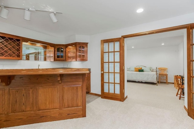 7711 N Montgall Ave, Kansas City, MO 64119 - indoor wet bar with light carpet, recessed lighting, baseboards, and french doors