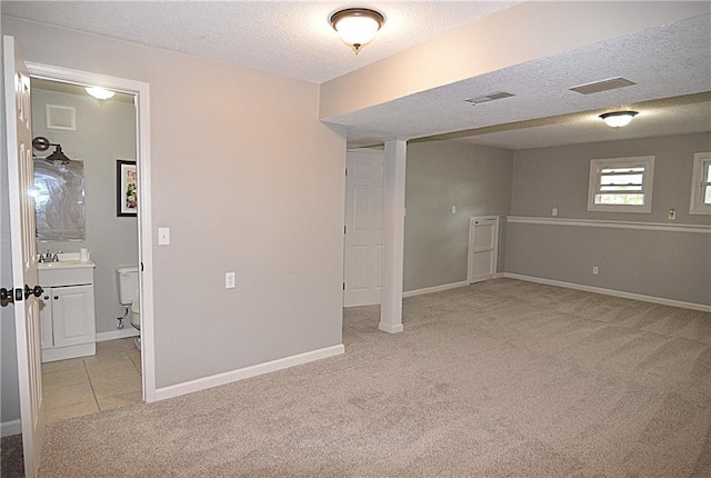 1748 NE Ridgeview Dr, Lees Summit, MO 64086 - empty room featuring light colored carpet, a textured ceiling, baseboards, and a sink