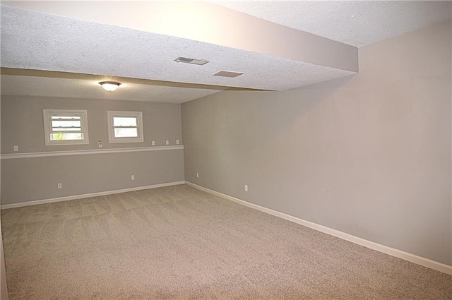 1748 NE Ridgeview Dr, Lees Summit, MO 64086 - empty room featuring a textured ceiling, light carpet, and baseboards