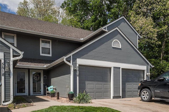 5516 66th Ter, Kansas City, MO 64151 - view of front of home with driveway, an attached garage, and roof with shingles