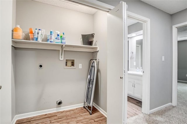 5516 66th Ter, Kansas City, MO 64151 - laundry area with hookup for a washing machine, hookup for an electric dryer, baseboards, and wood finished floors