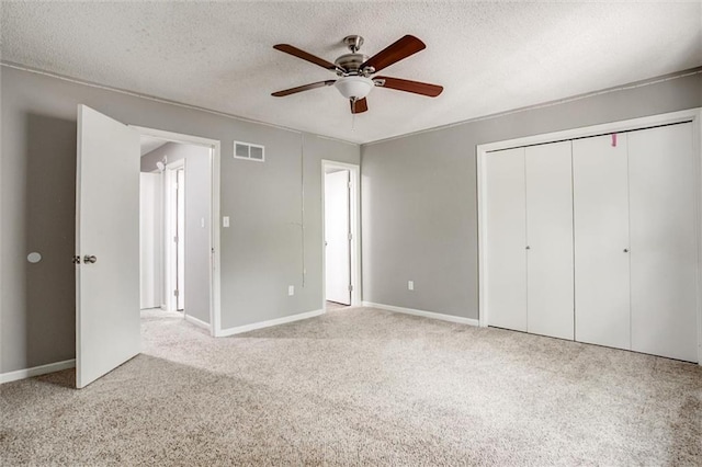 5516 66th Ter, Kansas City, MO 64151 - unfurnished bedroom featuring carpet floors, a closet, a textured ceiling, baseboards, and ceiling fan
