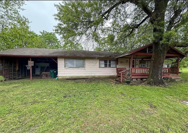 back of property with a lawn
