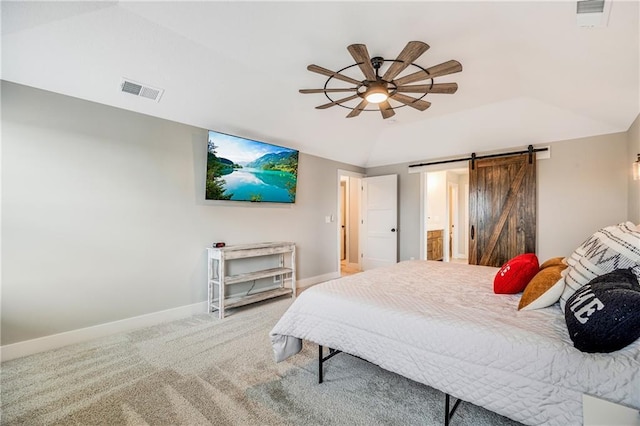carpeted bedroom with a barn door, baseboards, lofted ceiling, ceiling fan, and ensuite bath