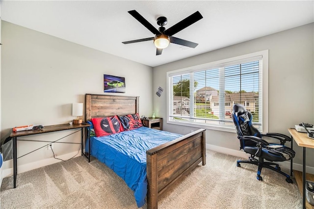 bedroom with carpet flooring, baseboards, a desk, and a ceiling fan