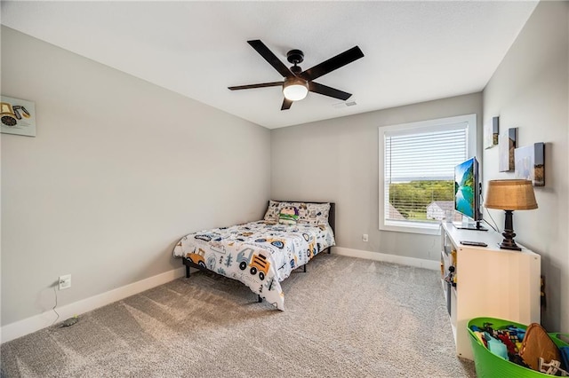 bedroom featuring baseboards, carpet flooring, and a ceiling fan