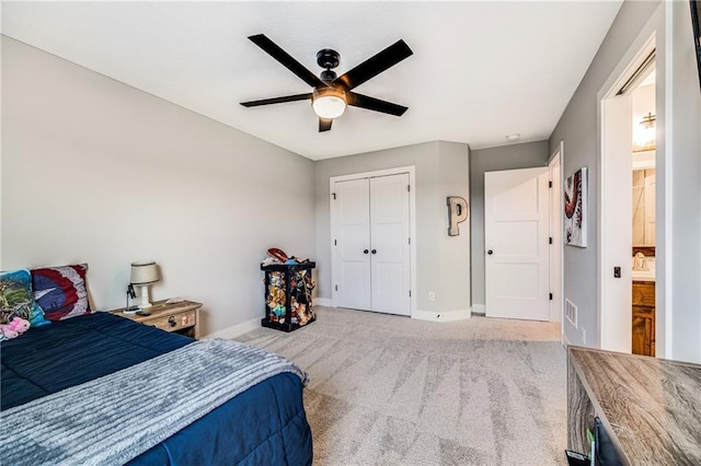 carpeted bedroom featuring baseboards, a closet, and ceiling fan